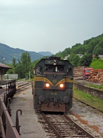 The engine backs past us to the front of the train (i.e., the flatcar at the left)