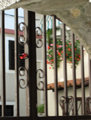 Hanging plants and fancy ironwork gates are both common